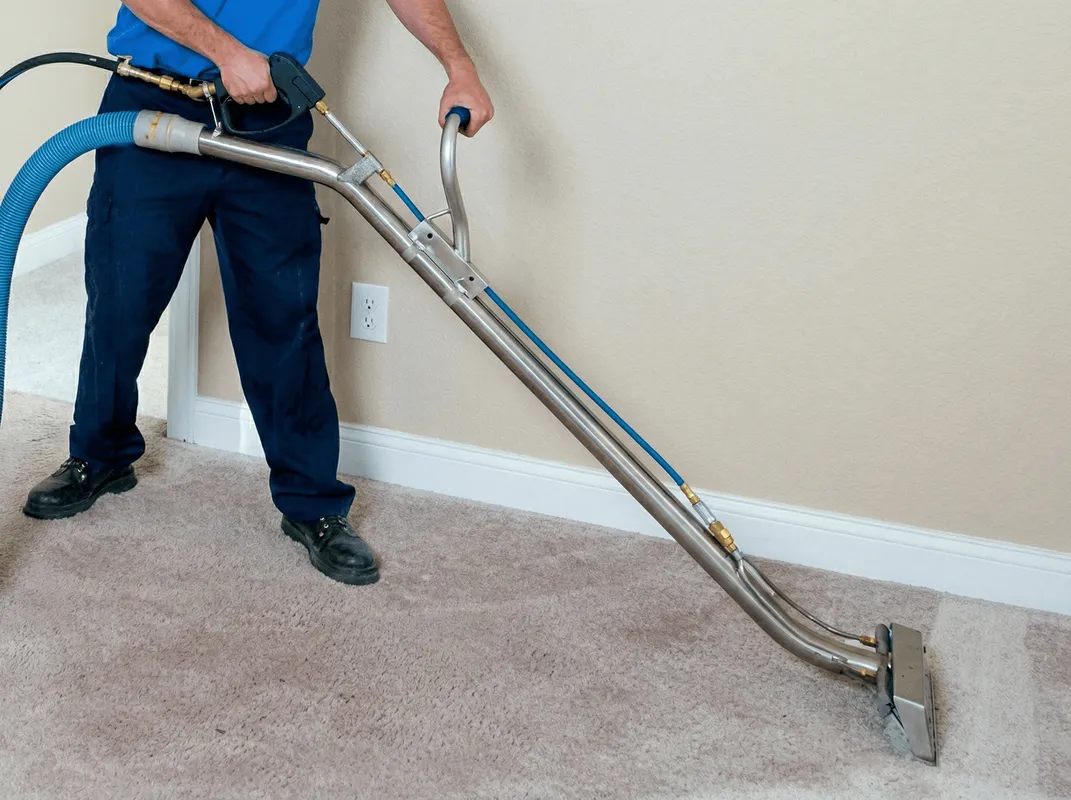 Professional operating a liquid removal machine on a carpeted floor in Eugene, OR